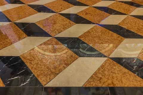 A close-up view of floor tiles with a 3D pattern in shades of brown, Stock Photos