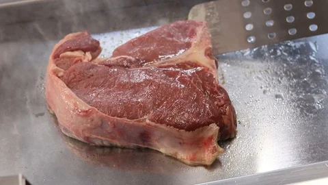 Close-up view of a Florentine steak cooking on the grill, chef cooking Stock Footage 121489919