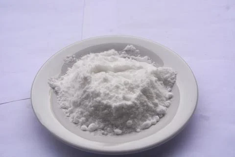 Close up view of flour placed on a small white plate. no people. Stock Photos