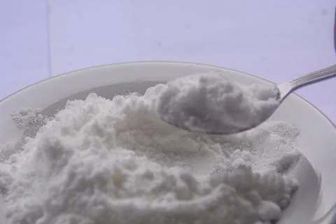 Close up view of flour placed on a small white plate. no people. Stock Photos