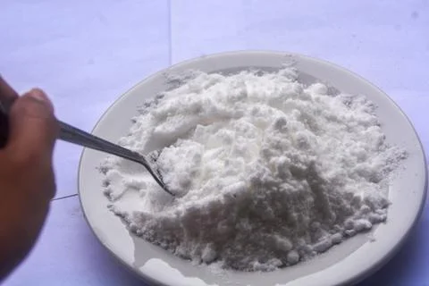 Close up view of flour placed on a small white plate. no people. Stock Photos