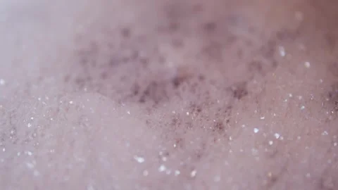 Close up view of foam and soapy bubbles on a moving water surface, self care Stock Footage 307592062
