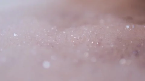 Close up view of foam and soapy bubbles on a moving water surface, self care Stock Footage 307592219