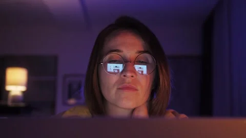 Close up view of focused woman wears computer glasses looking at laptop screen 스톡 동영상 255957853