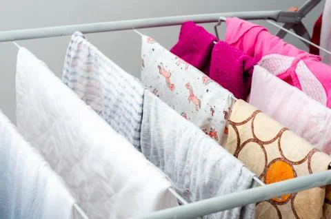 Close up view of foldable clothes drying , full of clothes drying on the balc Stock Photos