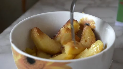Close-up view of the fork grabbing roasted potatoes from the decorative bowl Vidéo 271680651