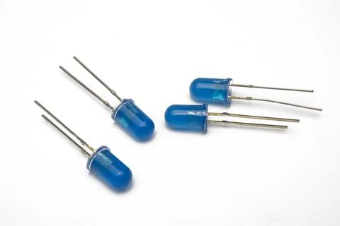 Close-up view of four blue LED (Light Emitting Diode) components. Stock Photos