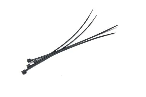 Close-up view of four cable ties on a white background. Foto stock