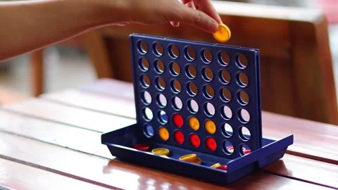 A close up view of a four in a row board game being played with red and yel.. Stock Footage 333488558