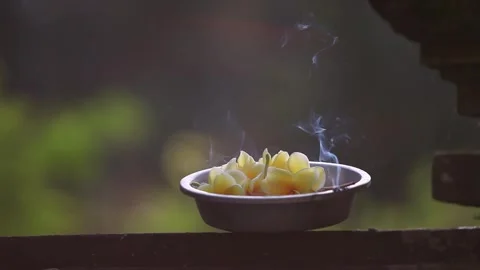 Close Up View of Frangipani Offering and Burning Incense Stick in Bali Stock Footage 345219242