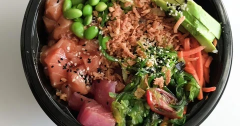 Close up view of fresh and delicious Hawaiian poke bowl dish Stock Footage 155074761