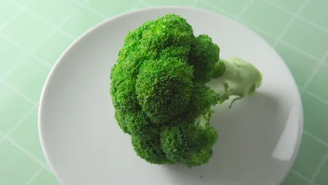 Close-up view of fresh broccoli. Green cabbage on white plate Stock Footage 264264122