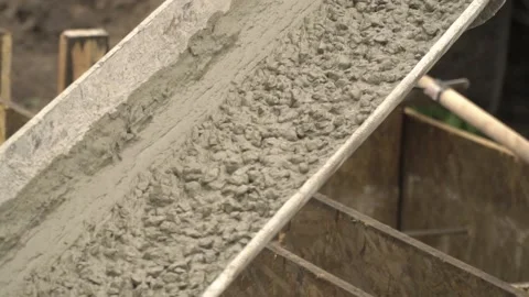 Close up view of fresh concrete pouring along the chute, construction site Stock Footage 158686464