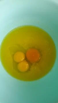 A Close-Up View of Fresh Eggs in a Light Blue Bowl Ready for Cooking, Showcasing Stock Photos