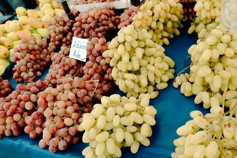 Close view of fresh grapes displayed in  local market. Many people visit mark Stock Photos