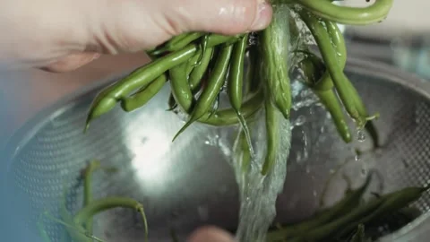 Close up view of fresh healthy string beans under a stream of clean water Stock Footage 343555528