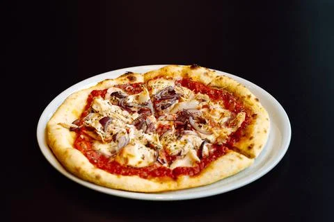 Close-up view to fresh pizza with tomato sauce, chicken and red onion Stock Photos