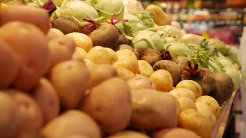 Close-up view of fresh potatoes and cabbages on display, capturing texture and Stock-Footage 307378334