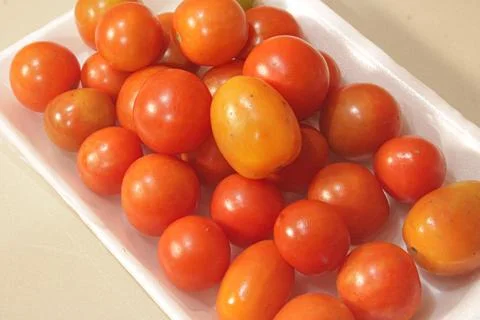 Close-Up View of Fresh Ripe Cherry Tomatoes on a White Tray Stock Photos