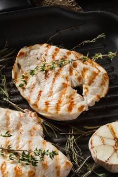 Close-up view of fresh roasted chicken fillet on grill pan Stock Photos