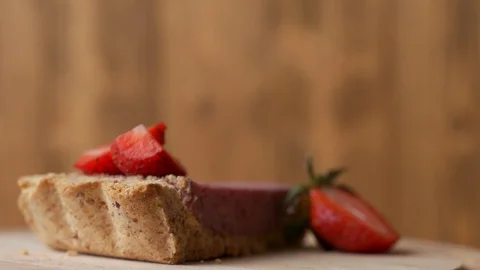 Close-up view of fresh strawberries with slice of strawberry cheesecake. Stock-Footage 129568834