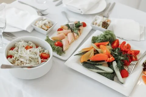 Close-up view of fresh vegetable platters with cucumbers and tomatoes alongside Stock Photos