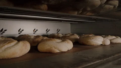 Close-up view of freshly baked bread rolls inside an industrial oven Stock Footage 340172327