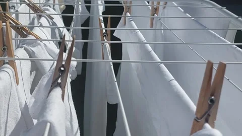 Close up view of freshly washed white laundry hanging to dry in the yard un.. Stock Footage 311000623