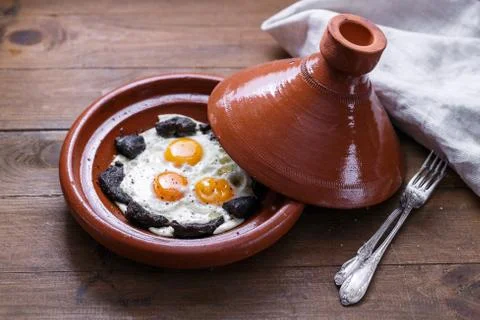 Close view of fried egg and beef in tajine dish, traditional Moroccan dish Stock Photos