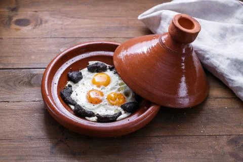 Close view of fried egg and beef in tajine dish, traditional Moroccan dish Stock Photos