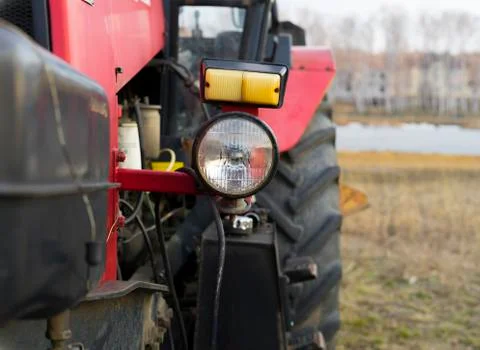 Close-up view front of a big red tractor. Copy space. Stock Photos
