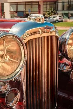 Close view of front grille, headlights and hood of Lagonda LG45 on sunny day Stock Photos