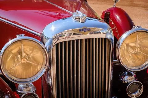 Close view of front grille, headlights and hood of Lagonda LG45 on sunny day Stock Photos