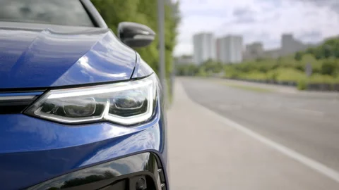 Close view of front LED headlights of blue car. beautiful modern car with LED Stock Footage 243965927