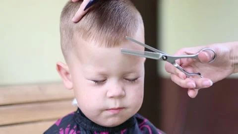 Close-up view of front portrait of a little baby boy with closed eyes while Stock Footage 157844379
