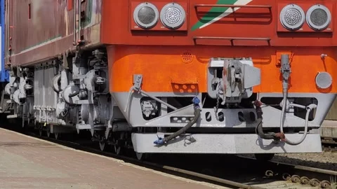 Close up view of front section of orange and gray diesel locomotive train parked Stock Footage 339866161