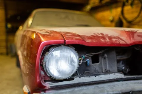 Close-up view front side classic car, front headlight of a broken dusty car Stock Photos