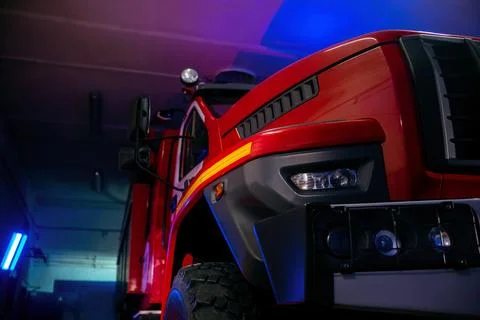 Close up view of the front side of fire truck parked in the garage station Stock Photos