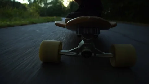 Close view to front wheels of the skateboard in light rays of the sun in Stock Footage 103840012