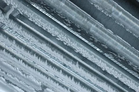 Close up view of frost patterns on a corrugated metal surface Stock Photos