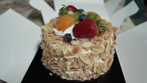 This is a close-up view of a fruit and almond cream cake with the box open. Stock Footage 310821068