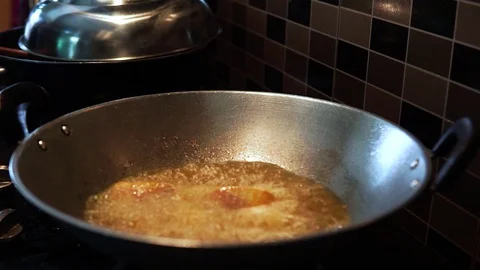 Close up view of frying a Tilapia fish in  a boiling oil. Stock Footage 127912720