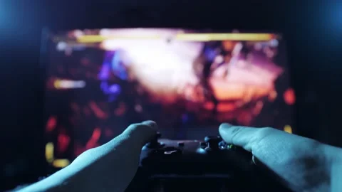 Close up view of a gamer's hands playing simulator video game on console using Video stock 170939184
