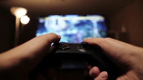 Close up view of a gamer's hands playing simulator video game on console using Video stock 171208165