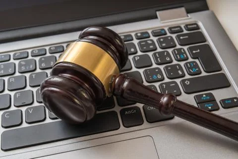 Close up view on gavel and computer keyboard. Internet security laws concept. Stock Photos