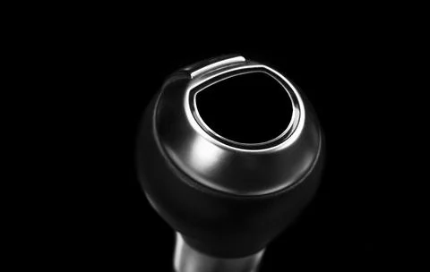 Close up view of a gear lever shift isolated on black background. Manual ge.. Stock Photos