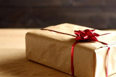 Close up view on gift box, covered by brown craft paper 스톡 사진