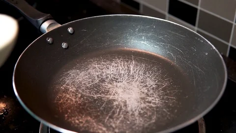 Close up view of girl making a pancake on a hot pan at the kitchen. Stock Footage 127984166