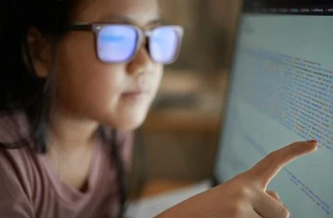 Close-up view of a girl reading code on the monitor Stock Photos