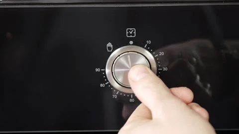 Close up view. Glass front panel of modern electric oven with shiny button Stock Footage 91666308